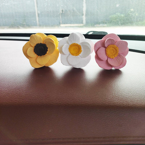 BloomDash floral ornaments displayed on a car dashboard